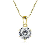Gold pendant with a large diamond on a white background