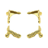Gold earring clips on a white background