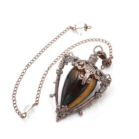 Necklace with a tiger's eye stone and ornate metalwork on a white background