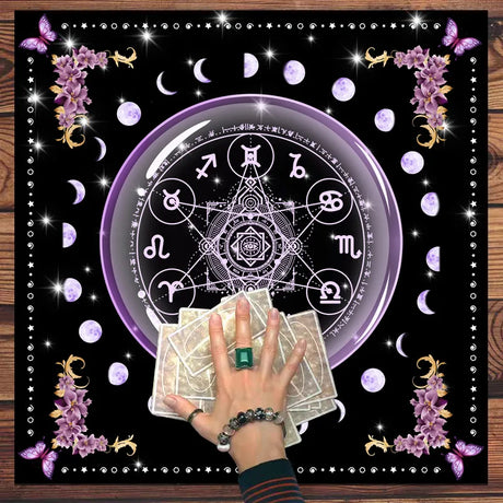 Talisman with astrological symbols, crystals, and hand holding cards on a decorative background