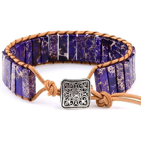 Bracelet with purple stone beads and a decorative clasp on a white background