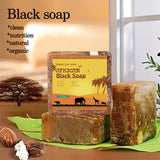 African Black Soap bar with packaging featuring a scenic label, placed on a green leaf with a blurred natural background.