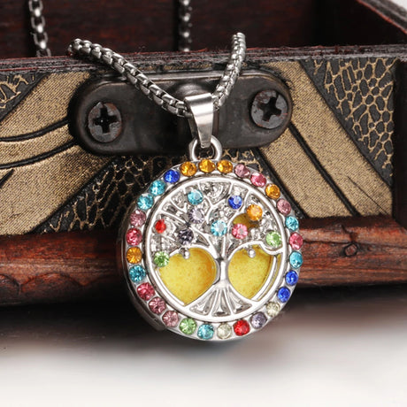 Necklace with a colorful tree of life pendant on a wooden surface