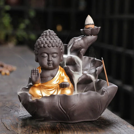 Buddha statue with incense burner on a wooden surface
