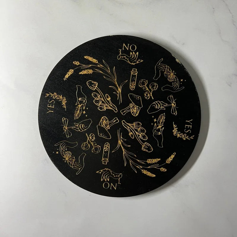 Black circular coaster with gold designs and text on a white background