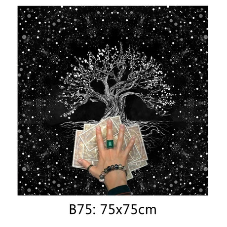 Hand holding tarot cards with a tree of life design against a starry night sky.