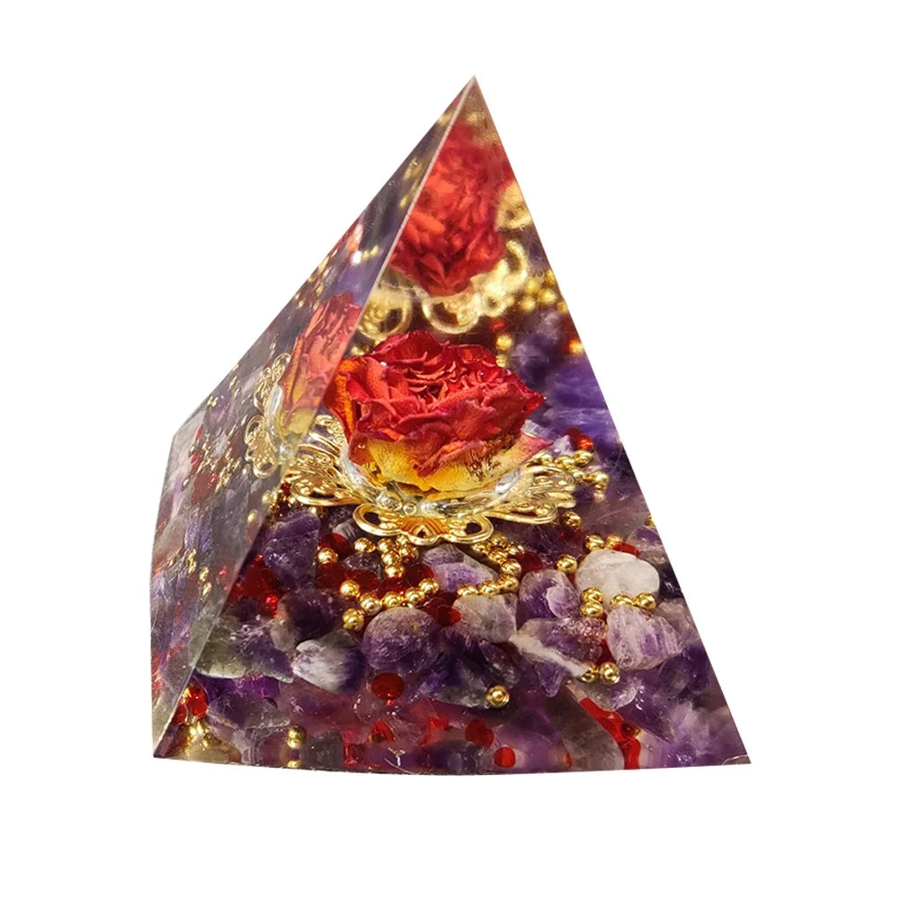 Pyramid-shaped crystal with embedded red roses and decorative elements on a white background