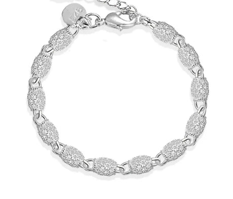 Silver bracelet with a textured design on a white background