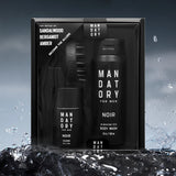 Mandatory Noir cologne and body wash set with water droplets on a dark background