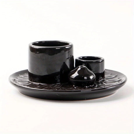 Black ceramic set with cup, saucer, and bowl on a white background