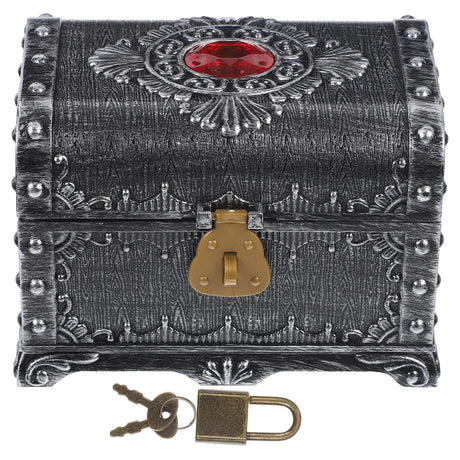 Decorative chest with intricate designs and a red gemstone on a white background