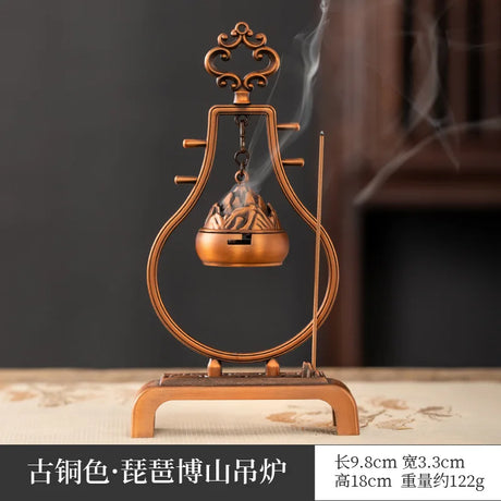 Bronze incense burner with smoke on a dark background