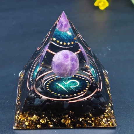 Pyramid-shaped crystal with a purple sphere on a dark background