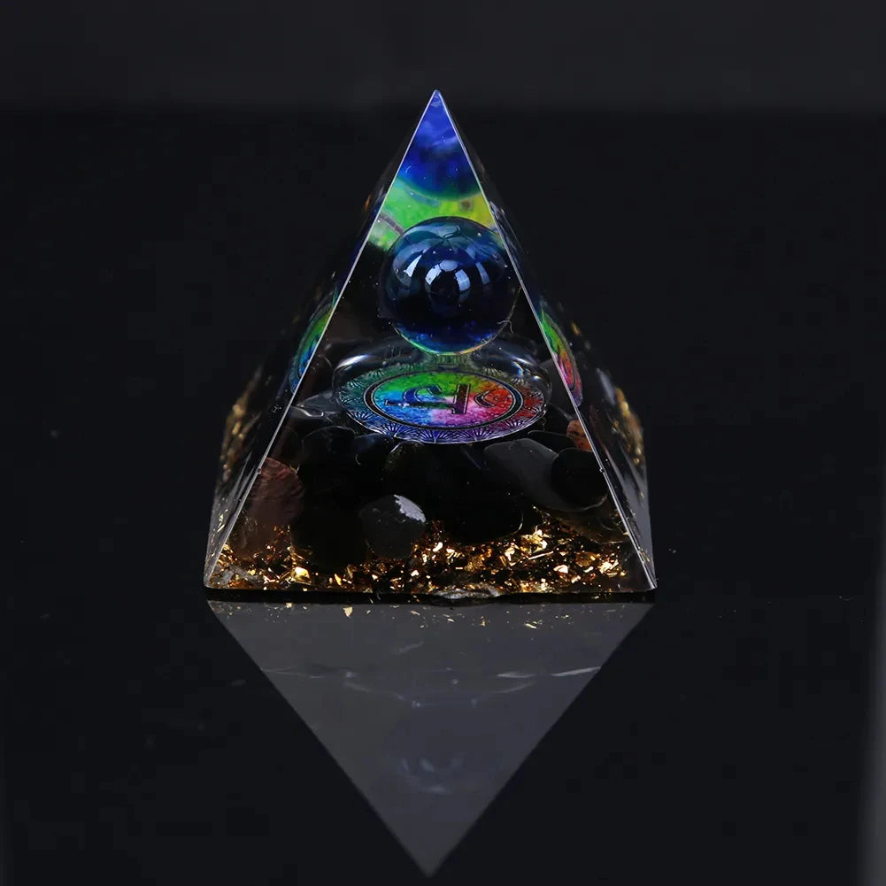 Triangular crystal pyramid with embedded eye design on a black background