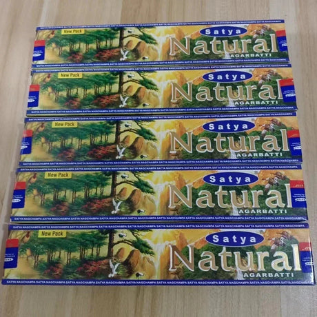 Multiple boxes of Satya Natural Agarbatti on a wooden surface