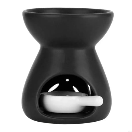 Black ceramic oil burner with a white dish inside on a white background