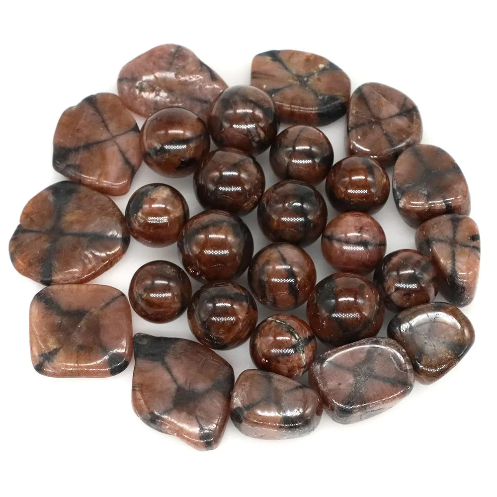 Collection of brown and black marbled stones on a white background