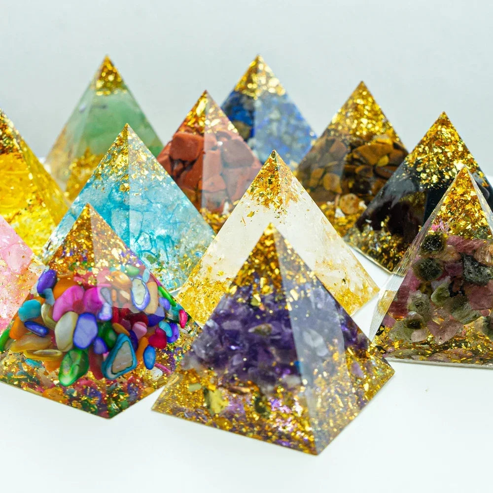 Colorful pyramid-shaped decorative items with embedded stones on a white background