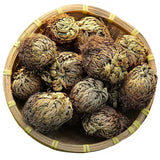 Tea balls in a bamboo basket on a white background