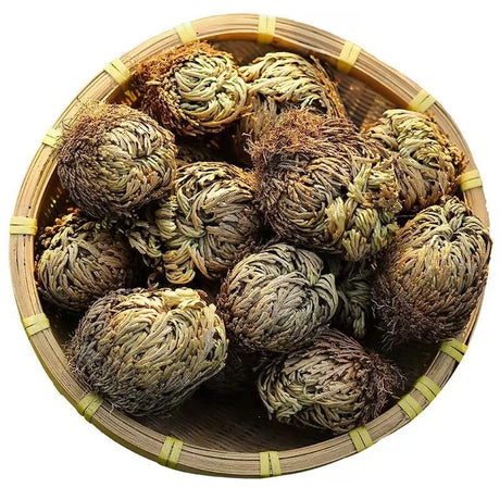 Tea balls in a bamboo basket on a white background