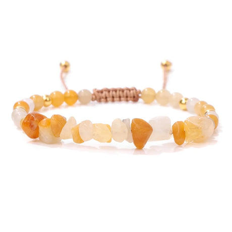 Beaded bracelet with yellow, white, and brown stones on a white background
