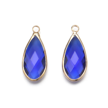 Two blue teardrop-shaped pendants with gold frames on a white background