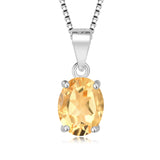 Silver pendant with a yellow gemstone on a white background