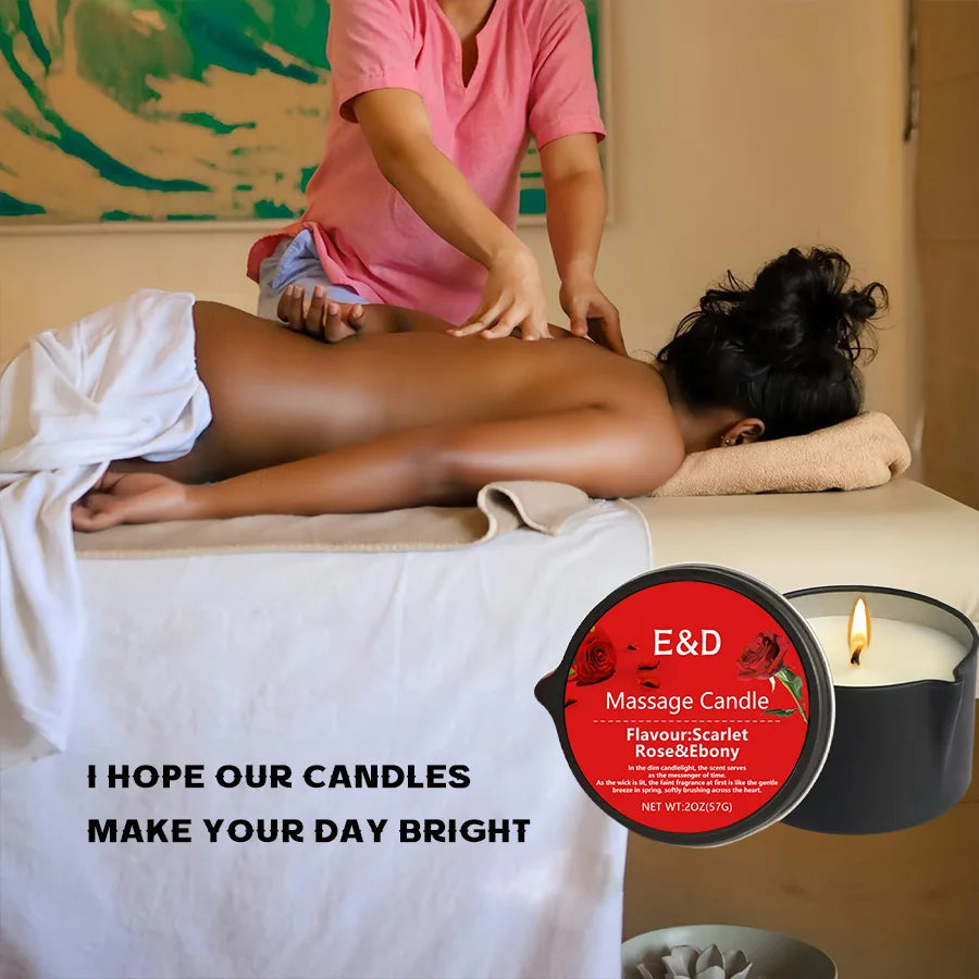 Person receiving a massage with a candle and E&D Massage Candle packaging in the foreground.