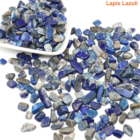 Lapis Lazuli stones with a white scoop on a white background
