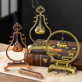 Three ornate incense burners on a dark background