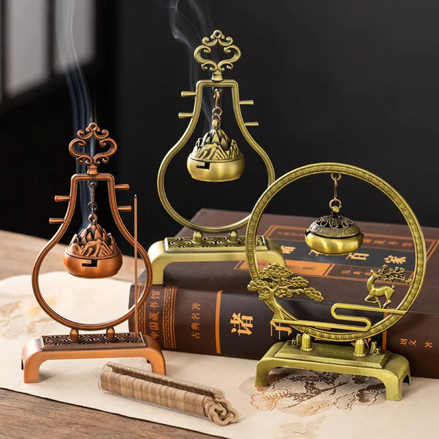 Three ornate incense burners on a dark background