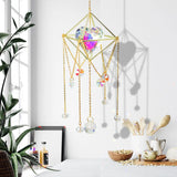 Decorative hanging crystal ball with gold frame and chains in a room setting.