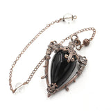Necklace with a black pendant on a white background