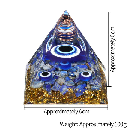 Pyramid-shaped object with blue eye designs and measurements on a white background