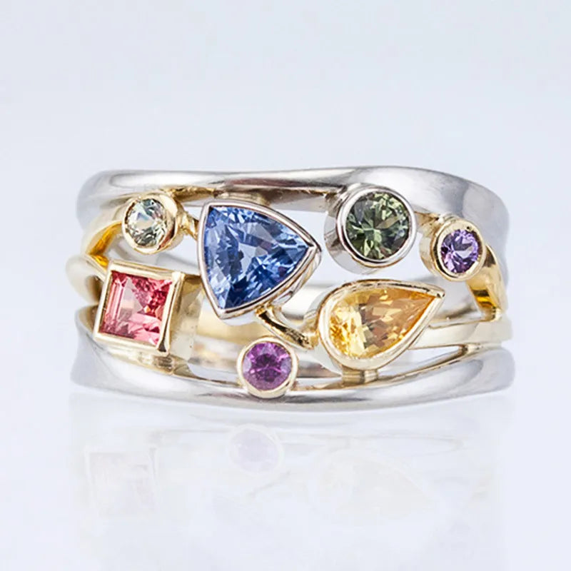 Multicolored gemstone ring on a light gray background
