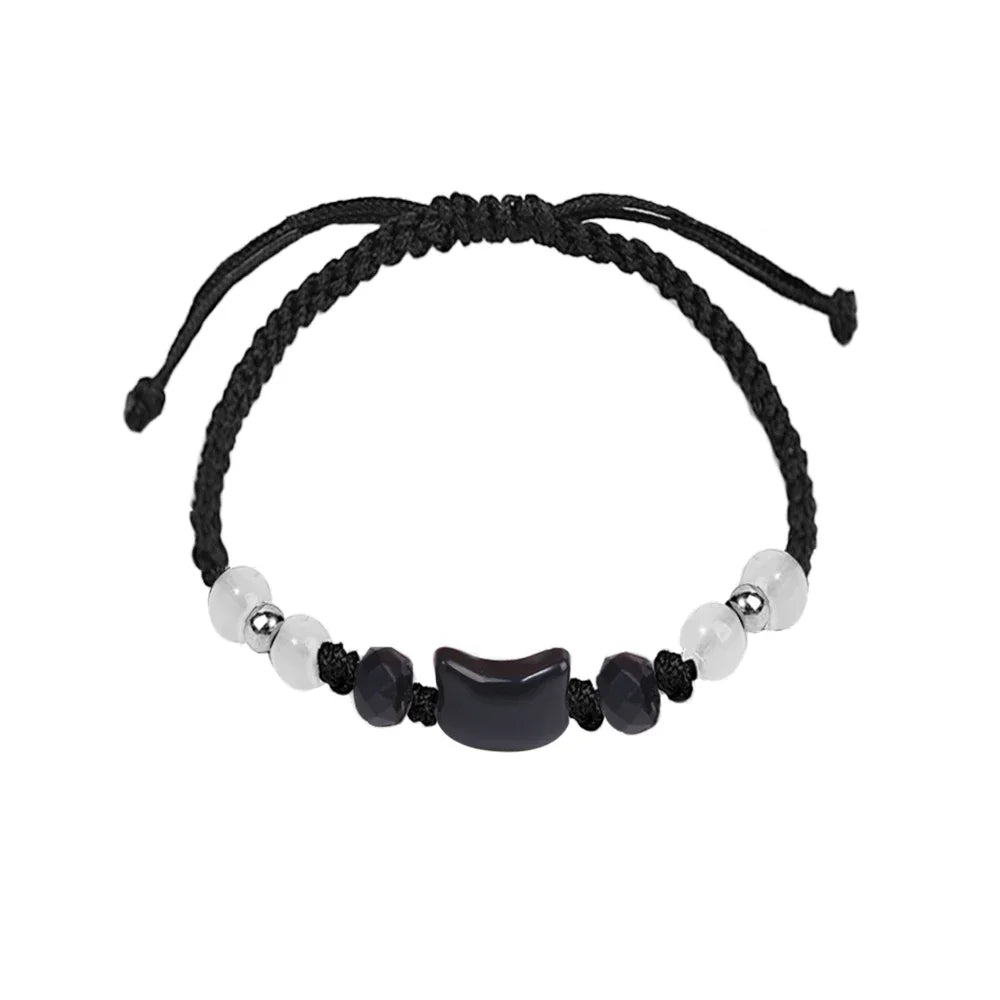 Black braided bracelet with beads on a white background