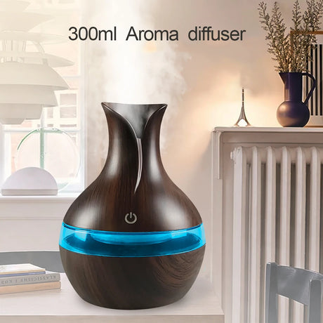 Aroma diffuser with wooden design and blue light on a table in a room.