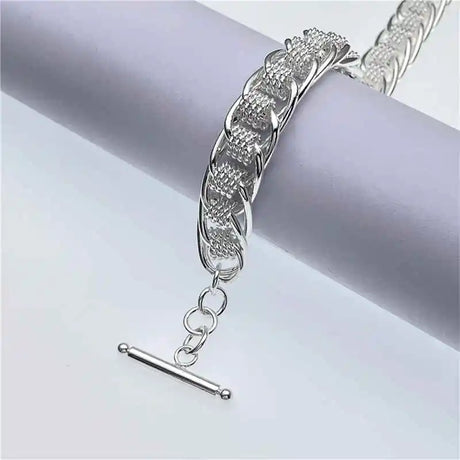 Silver bracelet on a light gray background