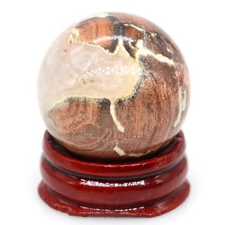 Decorative sphere with a wooden base on a white background