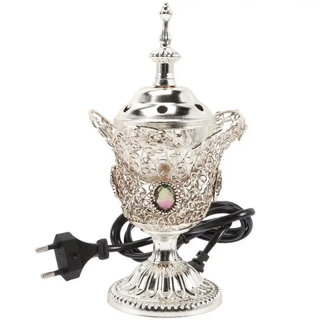 Decorative silver lamp with intricate designs on a white background