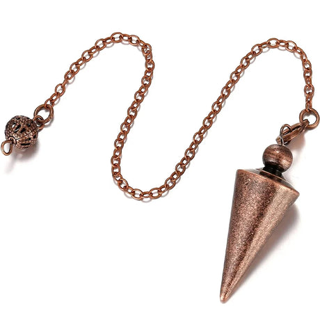 Copper-colored pendulum on a chain against a white background