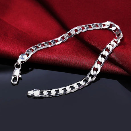 Silver chain bracelet on a red fabric background