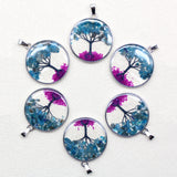 Set of six tree-themed pendants on a white background