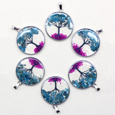 Set of six tree-themed pendants on a white background