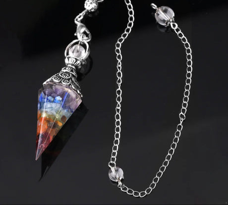Multicolored crystal pendant on a silver chain with a dark background