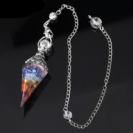 Multicolored crystal pendant on a silver chain with a dark background