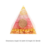 Triangular pyramid with pink and gold design on a white background