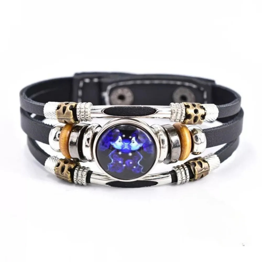 Multistrand bracelet with metallic and leather components on a white background
