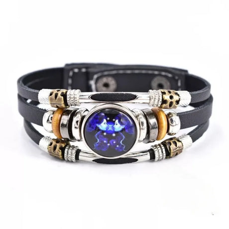 Multistrand bracelet with metallic and leather components on a white background