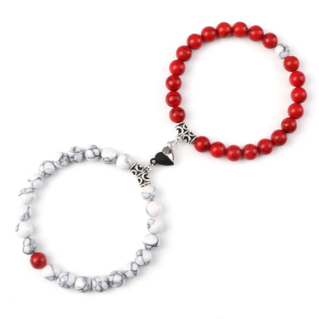 Two beaded bracelets, one red and one white with black accents, on a white background.
